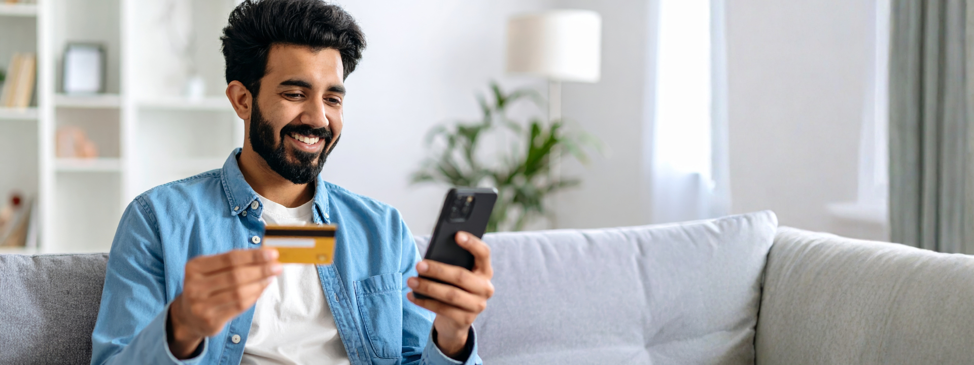 A person inputting credit card information into his cell phone
