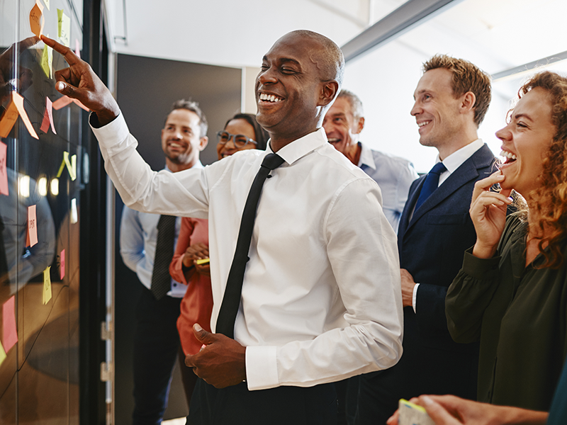 Group of coworkers laughing at a meeting