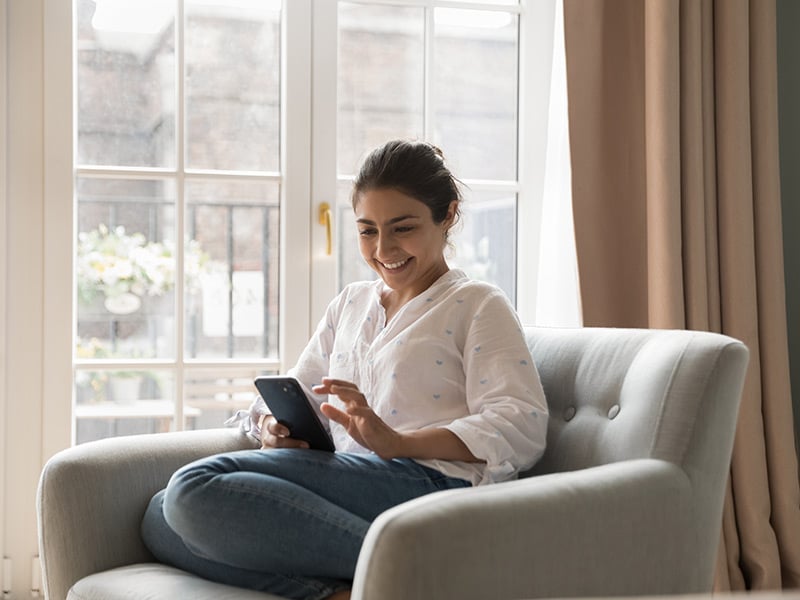 A customer at home using her smartphone