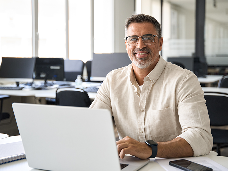 An employee working on a laptop at a desk