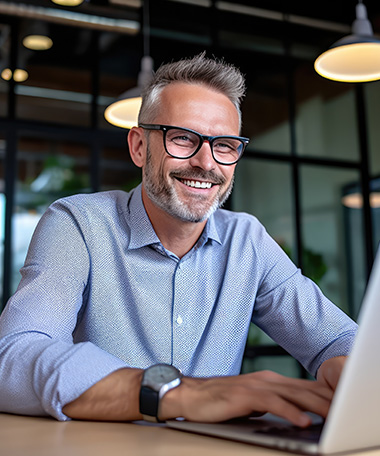 Employee smiling at his laptop