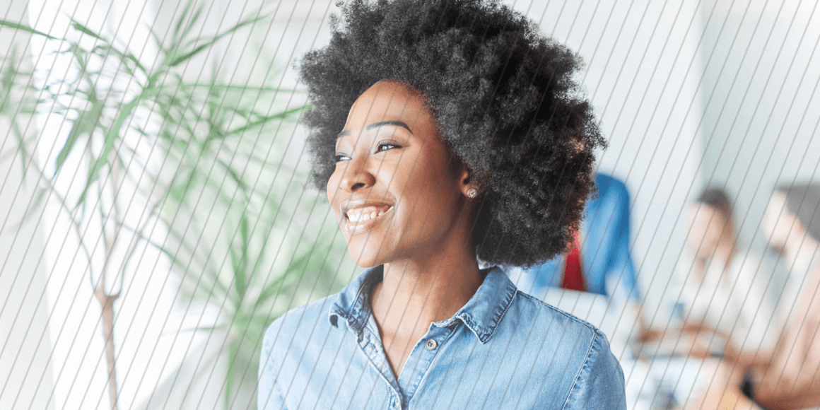 Happy employee looking optimistically out the window