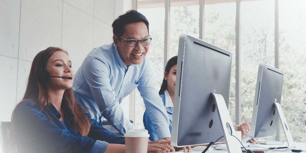 Contact Center Employee around computer monitors