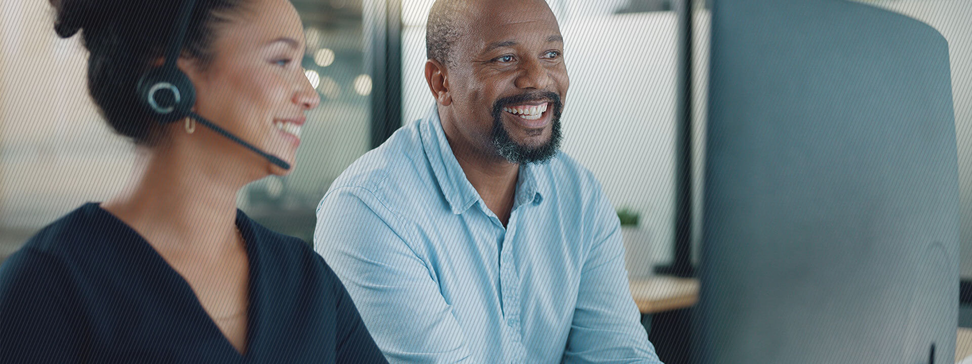 contact center employee with head set and man smiling