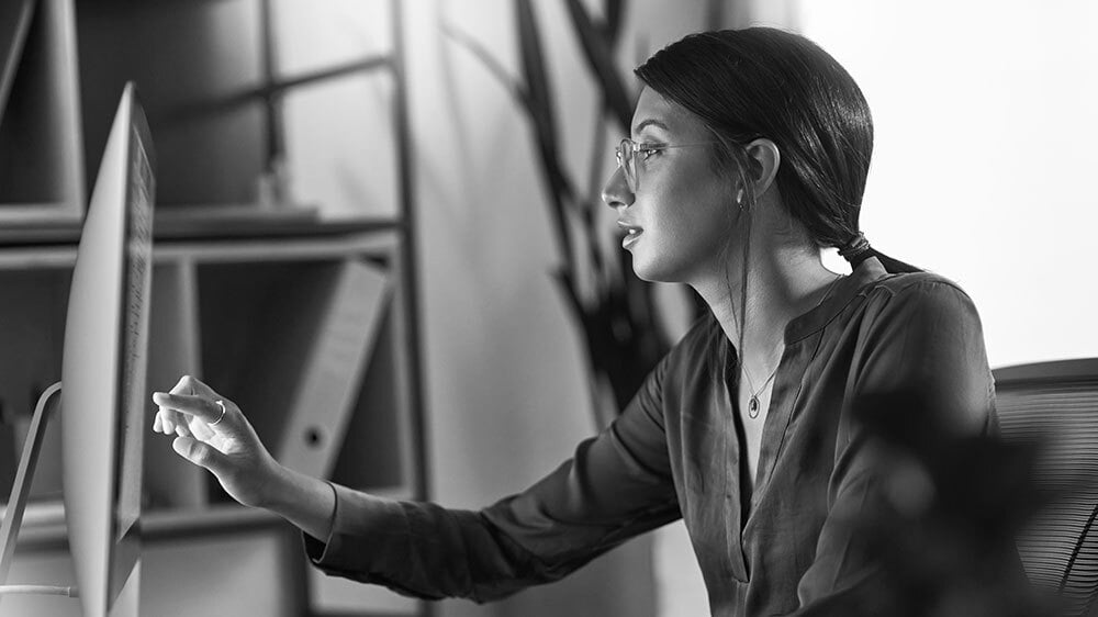 Businesswoman reading on a computer in the office.