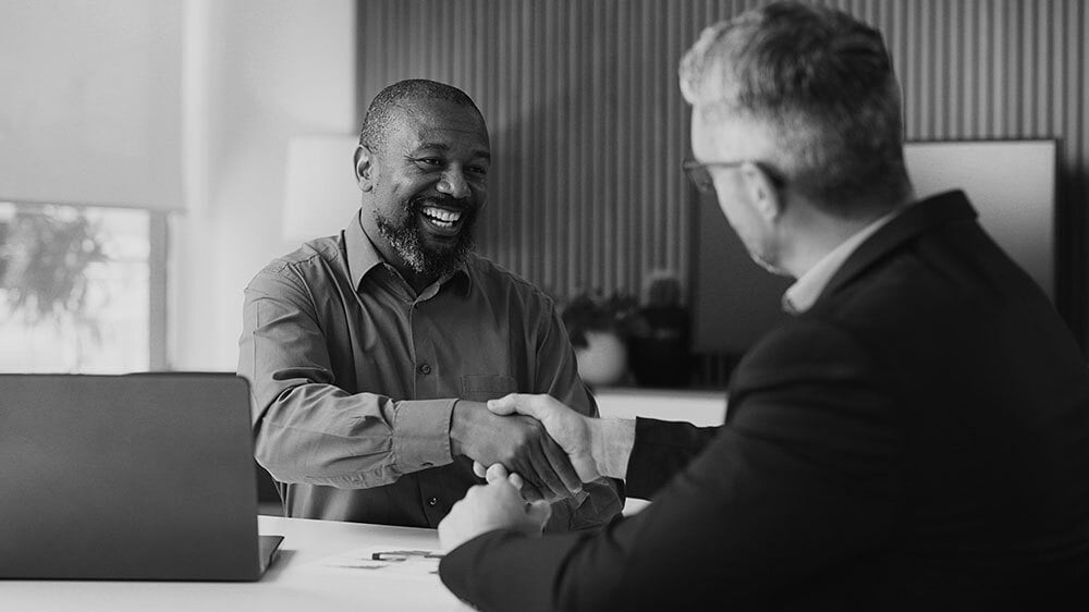 A man is shaking hands with a financial advisor.