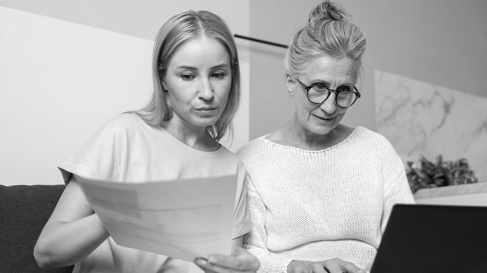 Mother and daughter checking documents on the computer