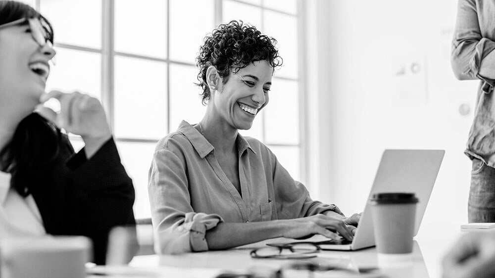 A team smiling while collaborating.