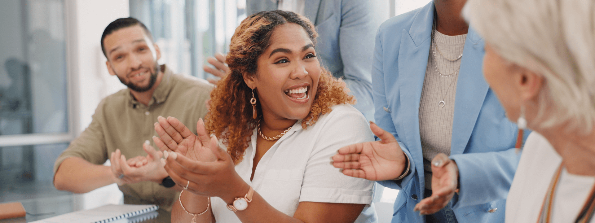 Happy employees celebrating during a meeting