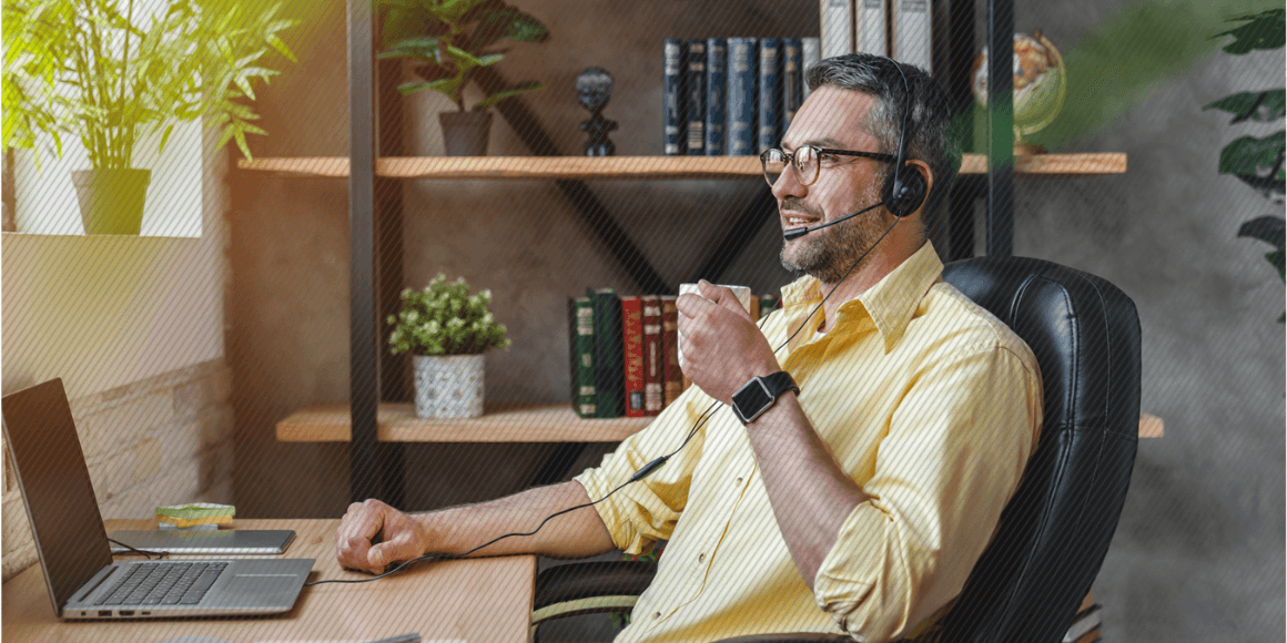 Employee taking a call from their home office while enjoying a cup of coffee