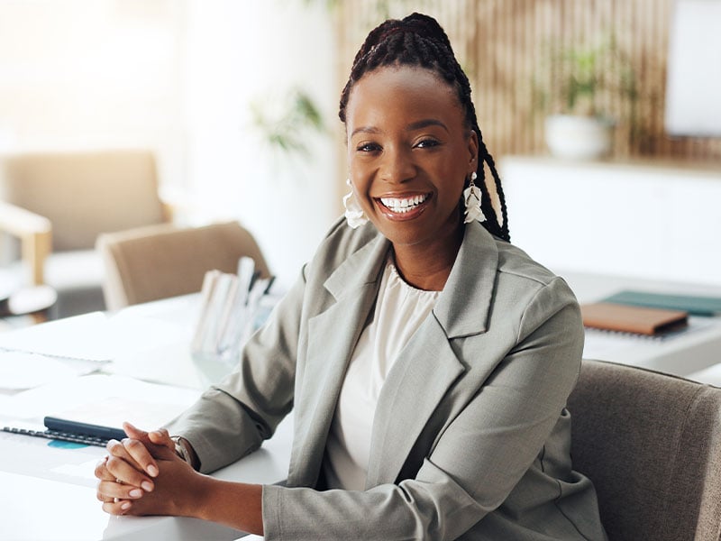 Employee smiling from her desk