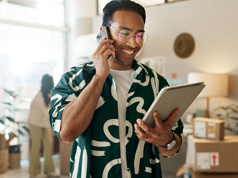 Retail manager on the phone while holding a tablet