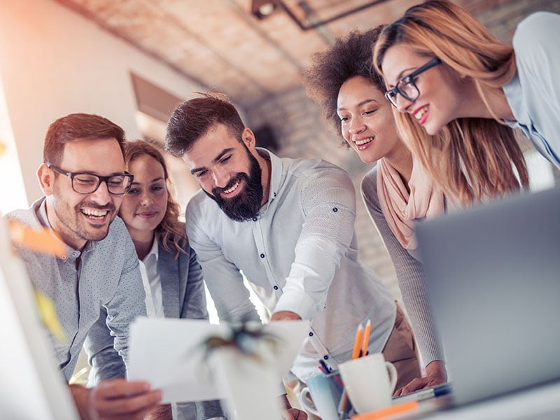 Team working happily together in an office environment