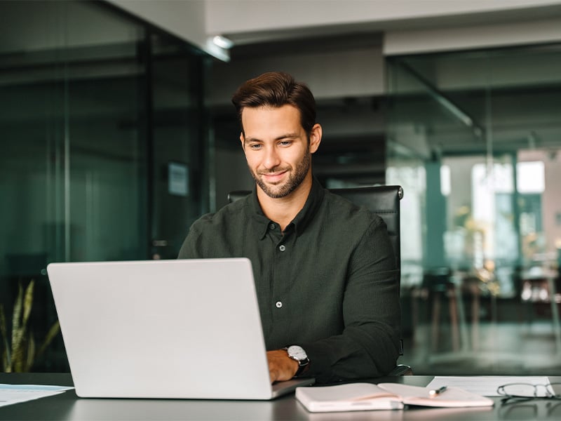 Business man working on laptop computer in company office
