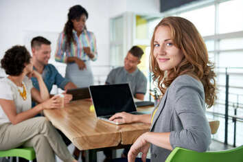 Image of a succesful casual business woman using laptop during meeting (1)-1