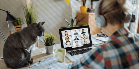 Woman sitting in her home office having a virtual meeting with her coworkers