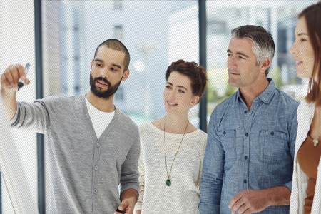 Man mapping out a customer journey on a whiteboard while talking to his fellow coworkers in an office