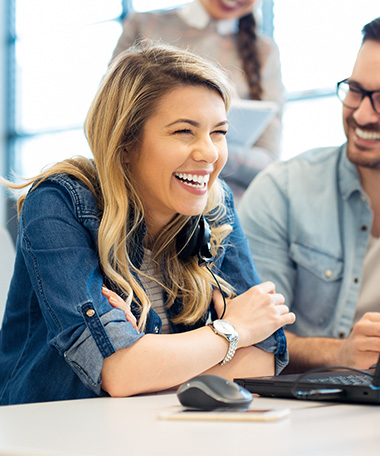 employees collaborating on a laptop