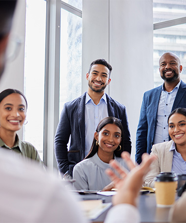 group of corporate employees listening to leader of a meeting