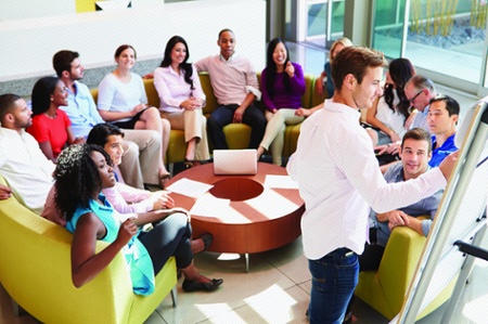 Corporate employee circle around white board