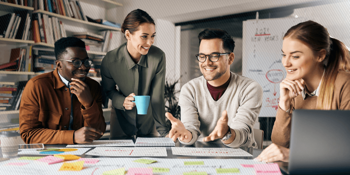 Featured image: A customer experience team mapping out and discussing their strategy in a meeting room.  - Read full post: 7 Essential Elements of Any CX Program