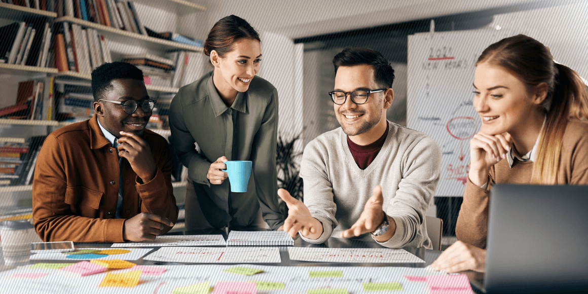 A customer experience team mapping out and discussing their strategy in a meeting room. 