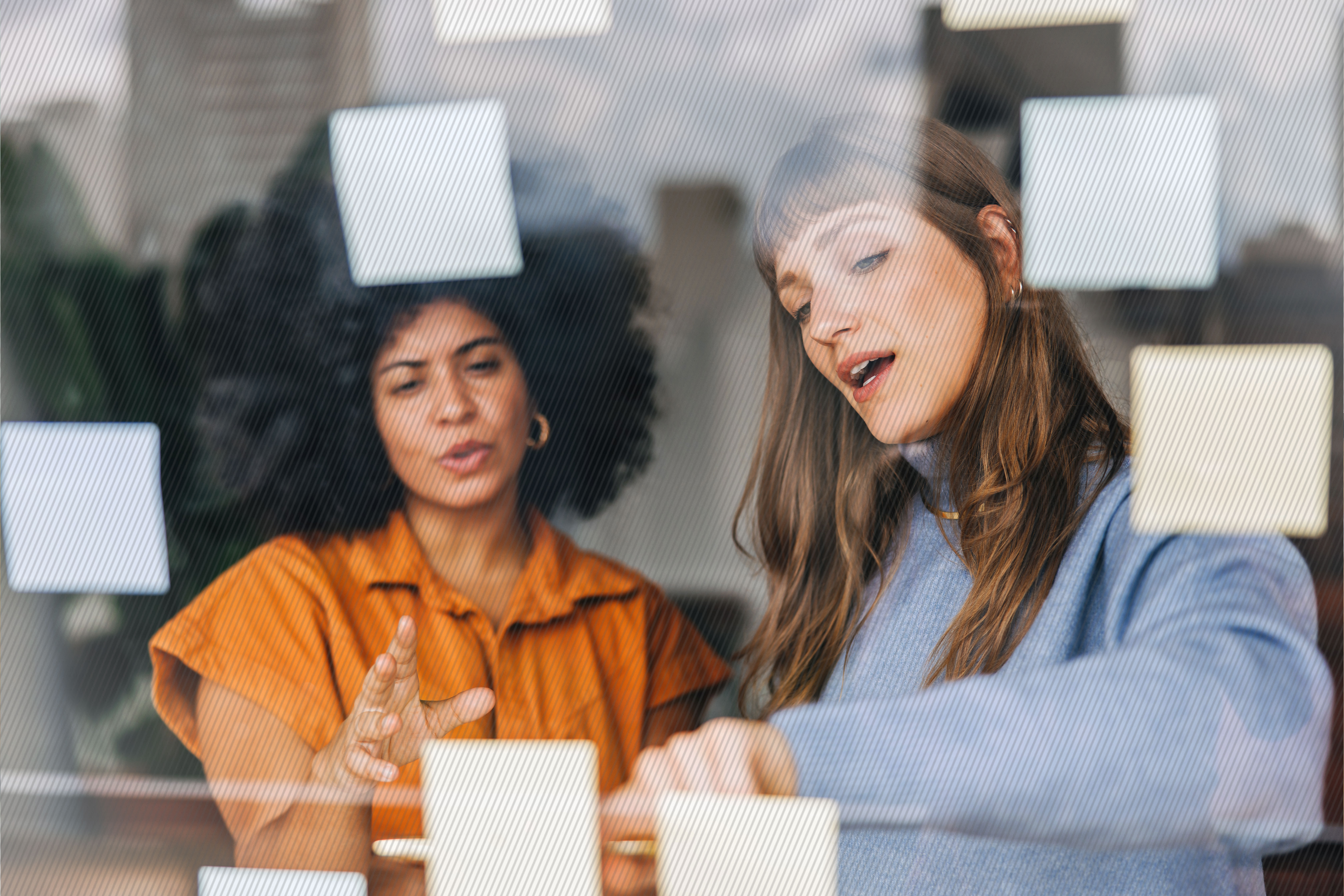Featured image: Two business women discussing their customer experience strategy - Read full post: 6 Ways to Optimize Touchpoints with Customer Experience Design