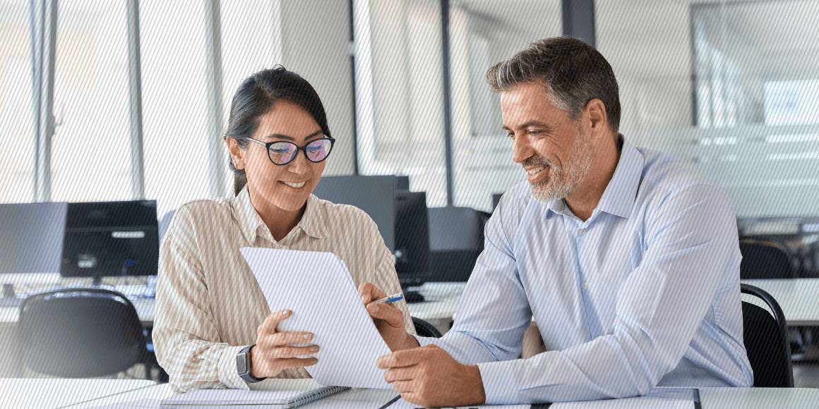 Two happy employees having a meeting in an office