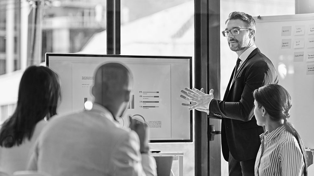 Businessman presenting with a graph on the screen