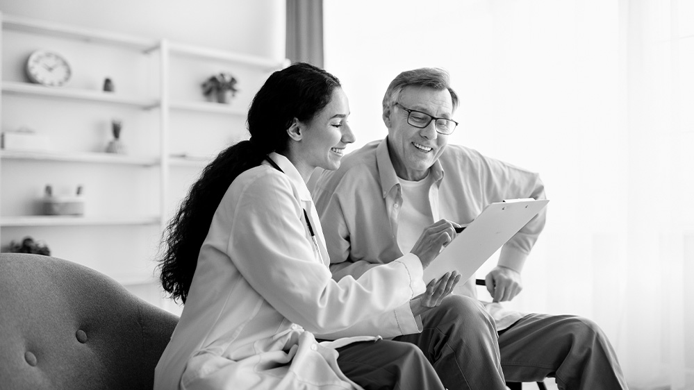 Man looking at documents with doctor