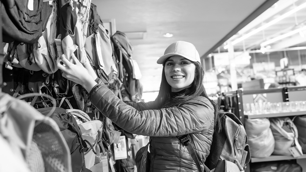 Woman shopping backpacking equipment