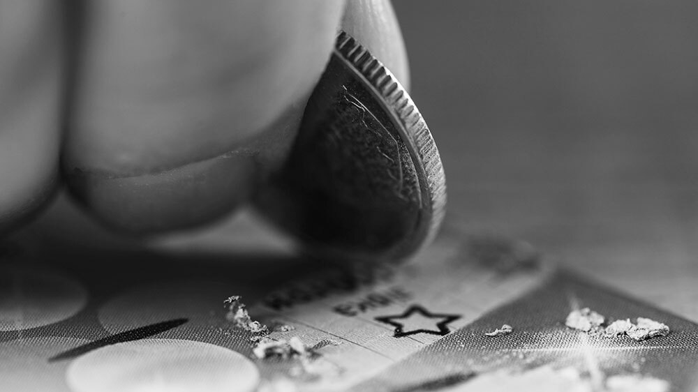Close-up view of a silver coin in hand of gambler