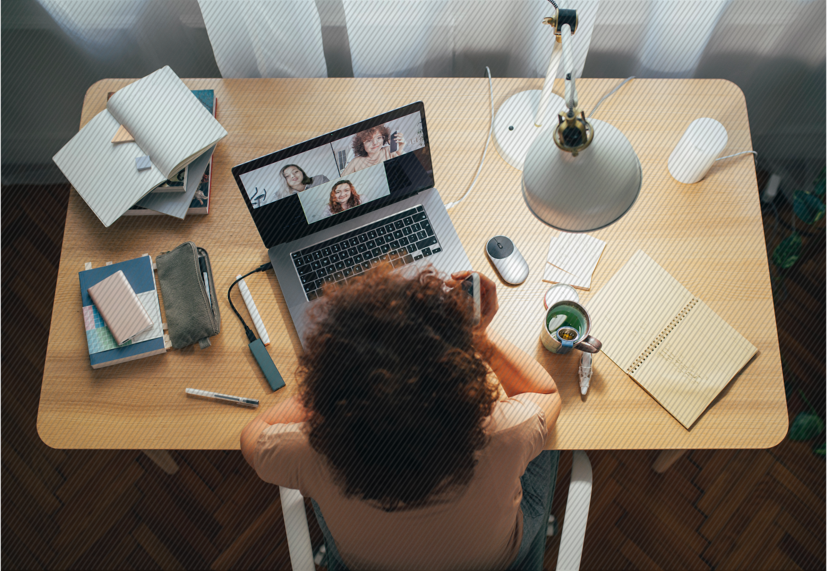 Featured image: Employee on a video conference call while sitting at desk - Read full post: Employee Experience | The Pros and Cons of Remote Work