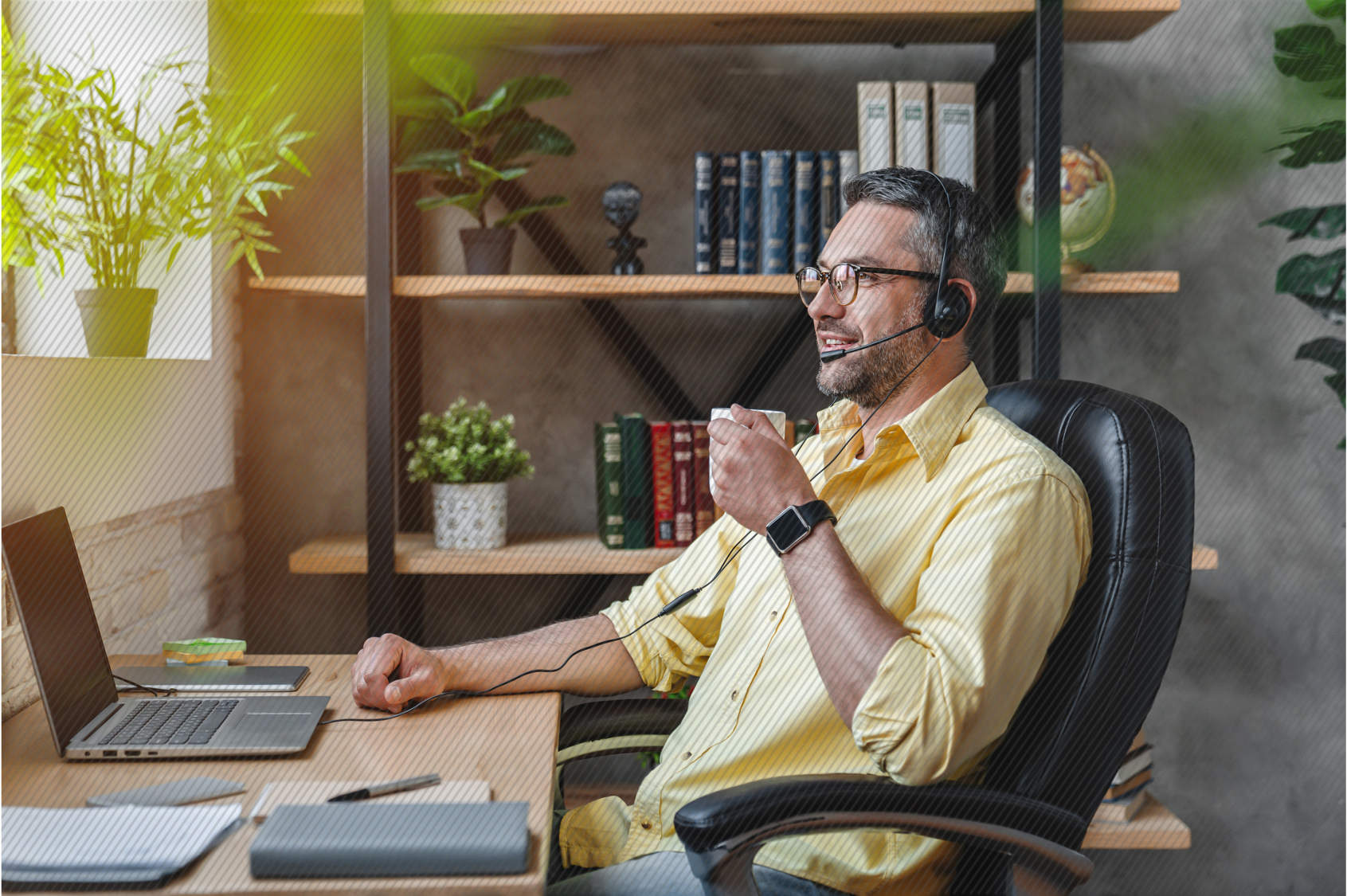 Employee working from home drinking a cup of coffee at his desk