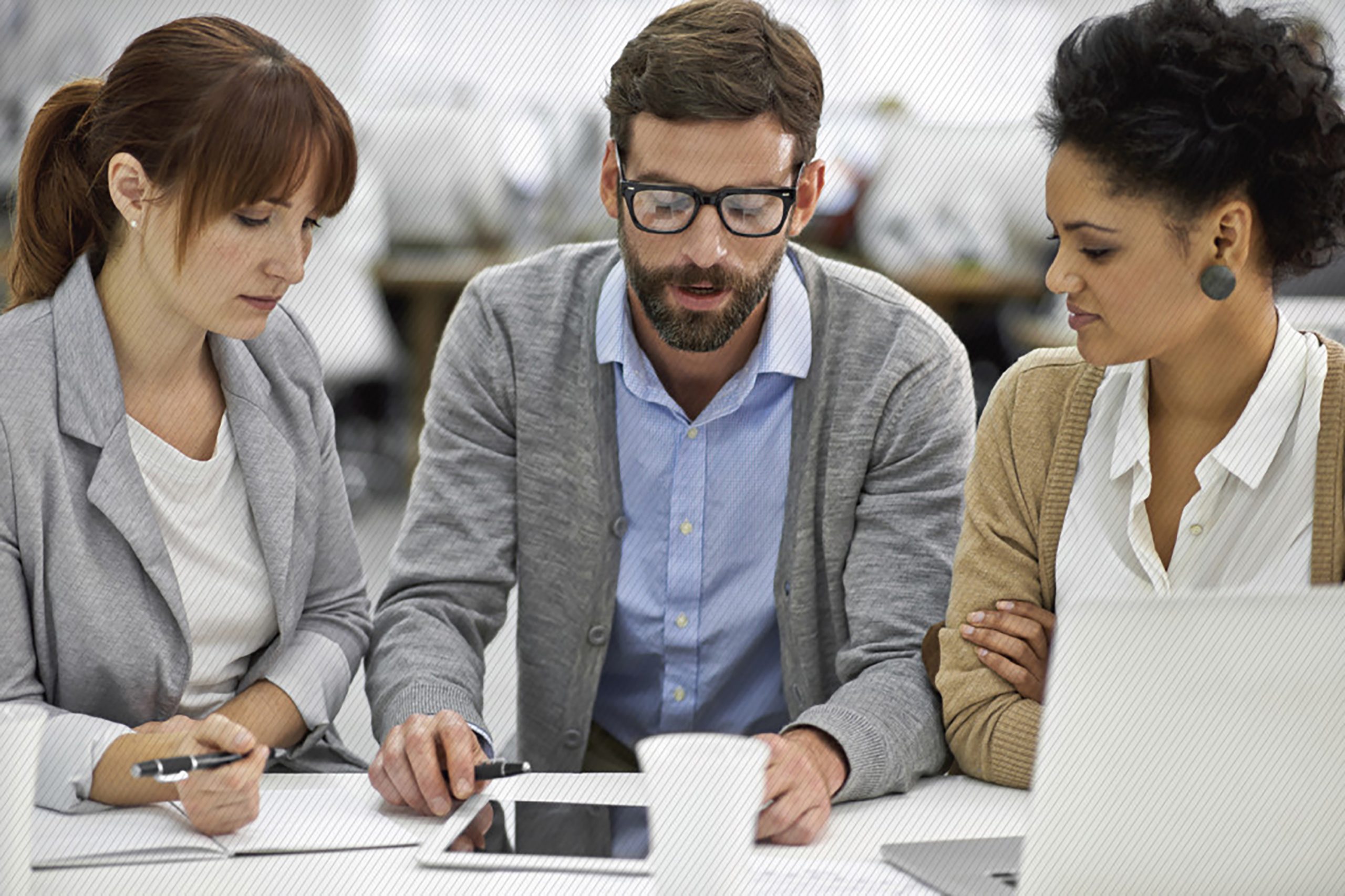 Featured image: Coworkers conducting a meeting while sitting at a table in the office  - Read full post: Give Your Online Customer Service A Reality Check Or Your Customers Will Do It For You