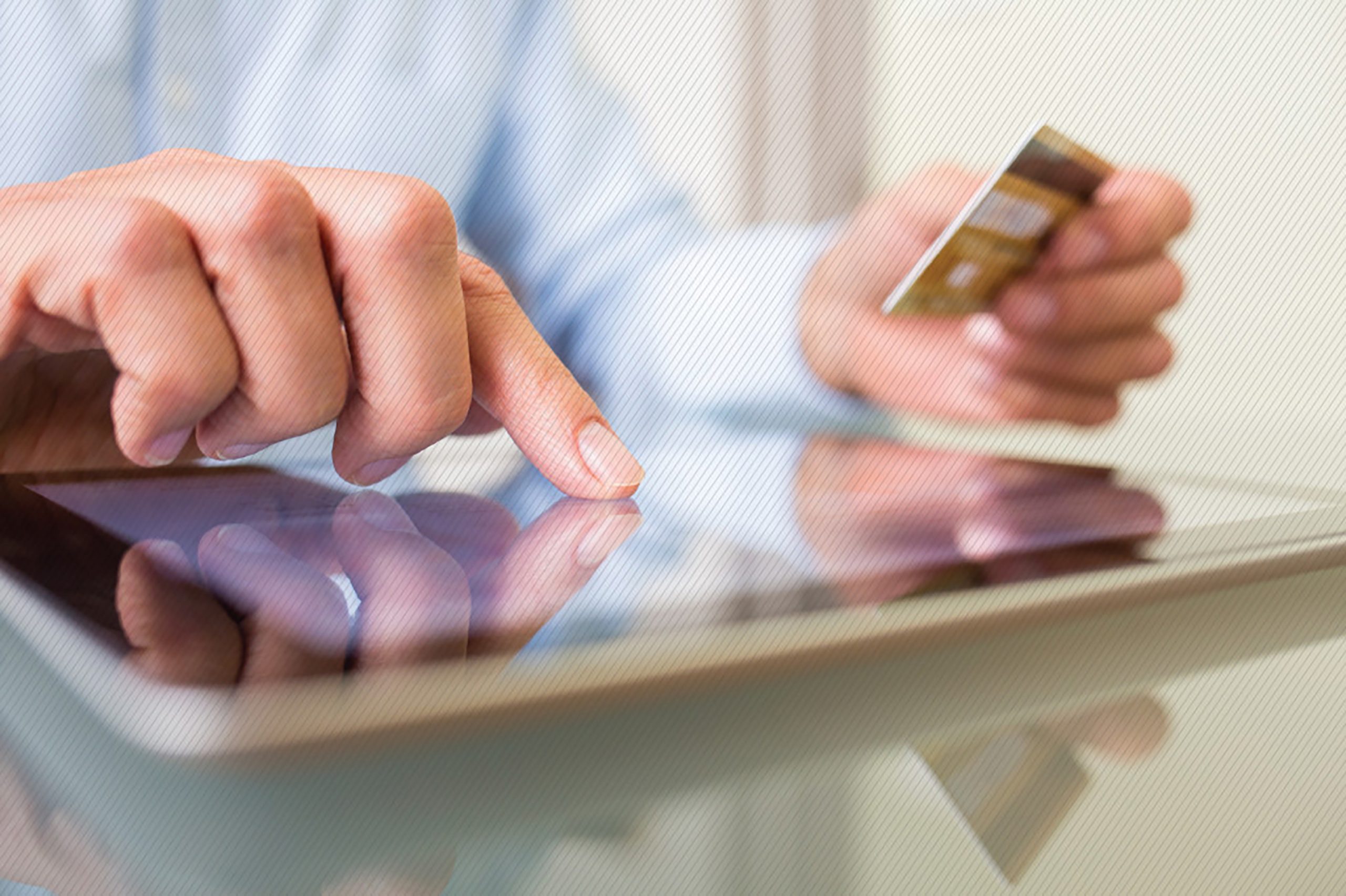 Featured image: Customer holding their credit card making an online purchase on their tablet.  - Read full post: How to Wow Your Customers with Personalized Experiences – And Why It’s Harder Than It Looks